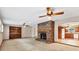 Open living room with brick fireplace, and view into updated kitchen with light wood cabinetry at 3072 Meyer Dr, Sarasota, FL 34239