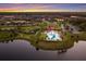 Aerial view features community pool and clubhouse, with lush greenery at 3210 Desert Plain Cv, Lakewood Ranch, FL 34211