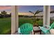 Covered back porch features a lush yard and view of the neighborhood at 3210 Desert Plain Cv, Lakewood Ranch, FL 34211