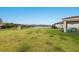 Expansive backyard with lush lawn offers plenty of space for outdoor activities and overlooks a peaceful lake at 3210 Desert Plain Cv, Lakewood Ranch, FL 34211