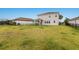 The home features a large backyard with lush grass and a black metal fence for privacy at 3210 Desert Plain Cv, Lakewood Ranch, FL 34211