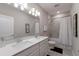 Modern bathroom with double sinks, quartz countertops, and a shower-tub combo at 3210 Desert Plain Cv, Lakewood Ranch, FL 34211