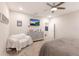 A bright bedroom featuring carpeting, a tv, ceiling fan, and a seating area at 3210 Desert Plain Cv, Lakewood Ranch, FL 34211