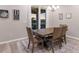 Cozy dining area features a wooden table set, stylish decor, and a view of the serene outdoor landscape at 3210 Desert Plain Cv, Lakewood Ranch, FL 34211