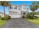 Attractive two-story home with a paved driveway, two-car garage, and mature landscaping under a bright blue sky at 3210 Desert Plain Cv, Lakewood Ranch, FL 34211