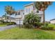Charming two-story home featuring a well-manicured lawn, paved driveway, and decorative front yard landscaping at 3210 Desert Plain Cv, Lakewood Ranch, FL 34211