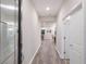 Bright hallway with wood floors leads to an open-concept living area, creating a seamless flow throughout the home at 3210 Desert Plain Cv, Lakewood Ranch, FL 34211