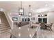 Open-concept kitchen with a large island, stainless appliances, and seamless flow into the living and dining areas at 3210 Desert Plain Cv, Lakewood Ranch, FL 34211