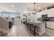 Open-concept kitchen with an island, stainless appliances, and adjacent dining area with sliding glass doors at 3210 Desert Plain Cv, Lakewood Ranch, FL 34211
