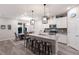 Modern kitchen with a large island, stylish pendant lighting, stainless appliances, and adjacent dining area at 3210 Desert Plain Cv, Lakewood Ranch, FL 34211