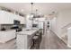 Bright, modern kitchen with a spacious island, stainless steel appliances, and sleek white cabinetry at 3210 Desert Plain Cv, Lakewood Ranch, FL 34211