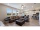 Spacious living room with a large sectional, ample natural light, and an open layout connecting to the kitchen at 3210 Desert Plain Cv, Lakewood Ranch, FL 34211