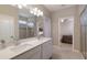 Modern main bathroom with double sinks, quartz countertops, and a glass-enclosed shower at 3210 Desert Plain Cv, Lakewood Ranch, FL 34211