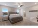 Spacious main bedroom with a tufted headboard, ceiling fan, and ensuite bathroom at 3210 Desert Plain Cv, Lakewood Ranch, FL 34211