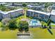 Aerial view of property with pool, lake, and surrounding buildings at 3562 Lake Bayshore Dr # 202, Bradenton, FL 34205