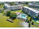 Wonderful aerial view of community, pool, lake with dock and buildings in a park-like setting at 3562 Lake Bayshore Dr # 202, Bradenton, FL 34205