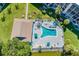 Aerial view of pool and deck with lounge chairs, set by the water in a beautifully landscaped yard at 3562 Lake Bayshore Dr # 202, Bradenton, FL 34205