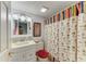Charming bathroom featuring a classic vanity, colorful shower curtain, and patterned accents for a unique style at 3562 Lake Bayshore Dr # 202, Bradenton, FL 34205