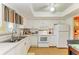 Cozy kitchen with white cabinets and appliances, and decorative touches at 3562 Lake Bayshore Dr # 202, Bradenton, FL 34205