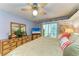 Comfortable main bedroom features a dresser, balcony access, and serene ambiance, ideal for relaxation at 3562 Lake Bayshore Dr # 202, Bradenton, FL 34205