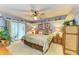 Serene main bedroom boasts nautical decor, a ceiling fan, and access to a private balcony at 3562 Lake Bayshore Dr # 202, Bradenton, FL 34205