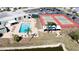 Community aerial view showcasing a swimming pool, tennis courts, and parking at 3915 40Th W St, Bradenton, FL 34205