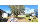 Spacious backyard with mature tree overlooking a serene pond at 3915 40Th W St, Bradenton, FL 34205