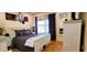 Bright bedroom featuring a white bedframe, stylish purple duvet, and a large window at 3915 40Th W St, Bradenton, FL 34205