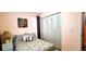 Relaxing bedroom featuring closet doors, soft lighting, and a comfortable patterned duvet at 3915 40Th W St, Bradenton, FL 34205