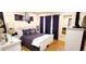 Comfortable bedroom featuring a white bedframe and a patterned purple duvet at 3915 40Th W St, Bradenton, FL 34205