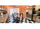 Inviting dining area featuring a checkered floor, stainless steel refrigerator, and sliding glass door at 3915 40Th W St, Bradenton, FL 34205