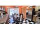 Bright dining room with checkered floors, stainless steel refrigerator and sliding glass doors at 3915 40Th W St, Bradenton, FL 34205