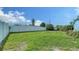 Large backyard with spacious grassy area, surrounded by a pristine fence, ideal for outdoor activities at 4015 52Nd Street W Ct, Bradenton, FL 34209