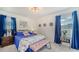 Inviting bedroom with bright blue bedding and curtains, perfect for a restful night's sleep at 4015 52Nd Street W Ct, Bradenton, FL 34209