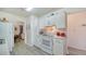 Efficient kitchen layout with white cabinets and appliances, seamlessly connecting to other living spaces at 4015 52Nd Street W Ct, Bradenton, FL 34209