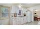 Well-lit kitchen with white cabinetry and a view to the adjacent dining area at 4015 52Nd Street W Ct, Bradenton, FL 34209