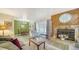 Inviting living area with hardwood floors, a stone fireplace, and open layout to the dining space at 4015 52Nd Street W Ct, Bradenton, FL 34209
