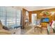 Comfortable living room features a stone fireplace, wood paneling, hardwood floors and natural light at 4015 52Nd Street W Ct, Bradenton, FL 34209