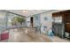 Relaxing sunroom with sliding glass doors, tile flooring, and neutral decor, perfect for unwinding at 4015 52Nd Street W Ct, Bradenton, FL 34209