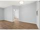 Light and airy bedroom featuring hardwood floors, and a doorway to the rest of the unit at 4138 Central Sarasota Pkwy # 1524, Sarasota, FL 34238
