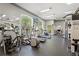 Community gym with modern exercise equipment, large windows and mirrors at 4138 Central Sarasota Pkwy # 1524, Sarasota, FL 34238
