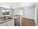 The kitchen has stainless steel appliances, a breakfast bar, and a sliding glass door to the outdoor balcony at 4138 Central Sarasota Pkwy # 1524, Sarasota, FL 34238