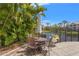 Community patio with umbrella table, four chairs and view of pond at 4138 Central Sarasota Pkwy # 1524, Sarasota, FL 34238
