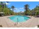 Large community pool surrounded by lush tropical landscaping and palm trees at 4138 Central Sarasota Pkwy # 1524, Sarasota, FL 34238