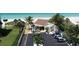 Charming beach house exterior surrounded by palm trees and parking spaces at 4310 Falmouth Dr # 305, Longboat Key, FL 34228