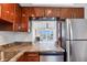 Modern kitchen with stainless appliances and a pass through to living area and water views at 4310 Falmouth Dr # 305, Longboat Key, FL 34228
