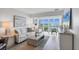 Cozy living room with water views, and light colored contemporary furniture at 4310 Falmouth Dr # 305, Longboat Key, FL 34228