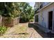 The fenced backyard with mature trees and a sliding glass door at 4639 Sloan Ave, Sarasota, FL 34233
