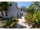 The backyard features a paved pathway and beautiful landscaping with mature trees at 4639 Sloan Ave, Sarasota, FL 34233