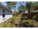 A backyard is surrounded by trees and a fence at 4639 Sloan Ave, Sarasota, FL 34233